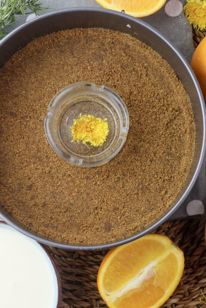 image showing how to form the crust of the cake with crushed cookies and butter